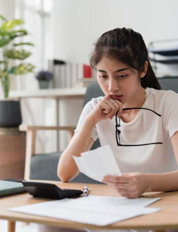 Young Woman Looks at Bills