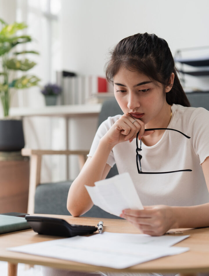 Young Woman Looks at Bills